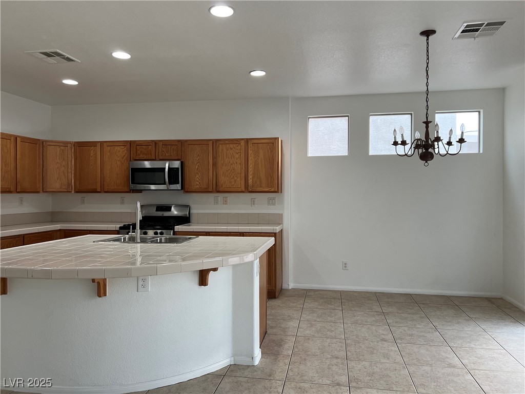 Undisclosed Address Las Vegas, NV 89142 - Photo 6 of 23 Kitchen with visible vents, brown cabinets, stainl