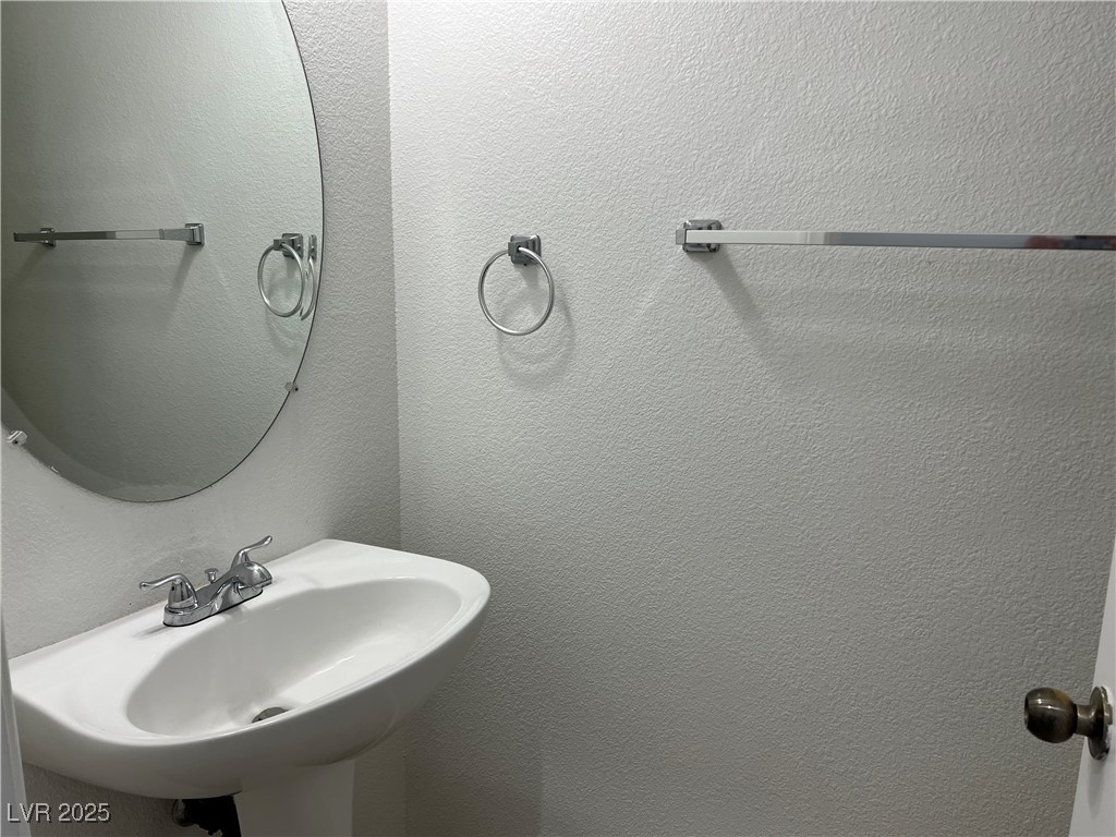 Undisclosed Address Las Vegas, NV 89142 - Photo 9 of 23 Bathroom with a textured wall and a sink