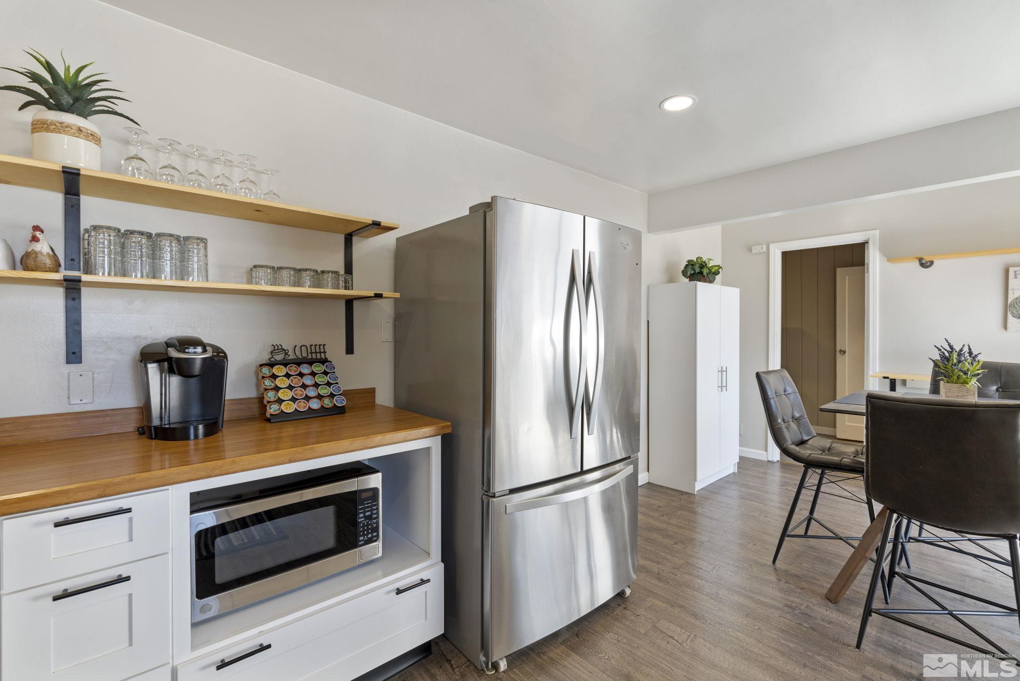 840 Bates Avenue Reno, NV 89502 - Photo 11 of 39 a kitchen with stainless steel appliances granite countertop a refrigerator a stove and a wooden floors