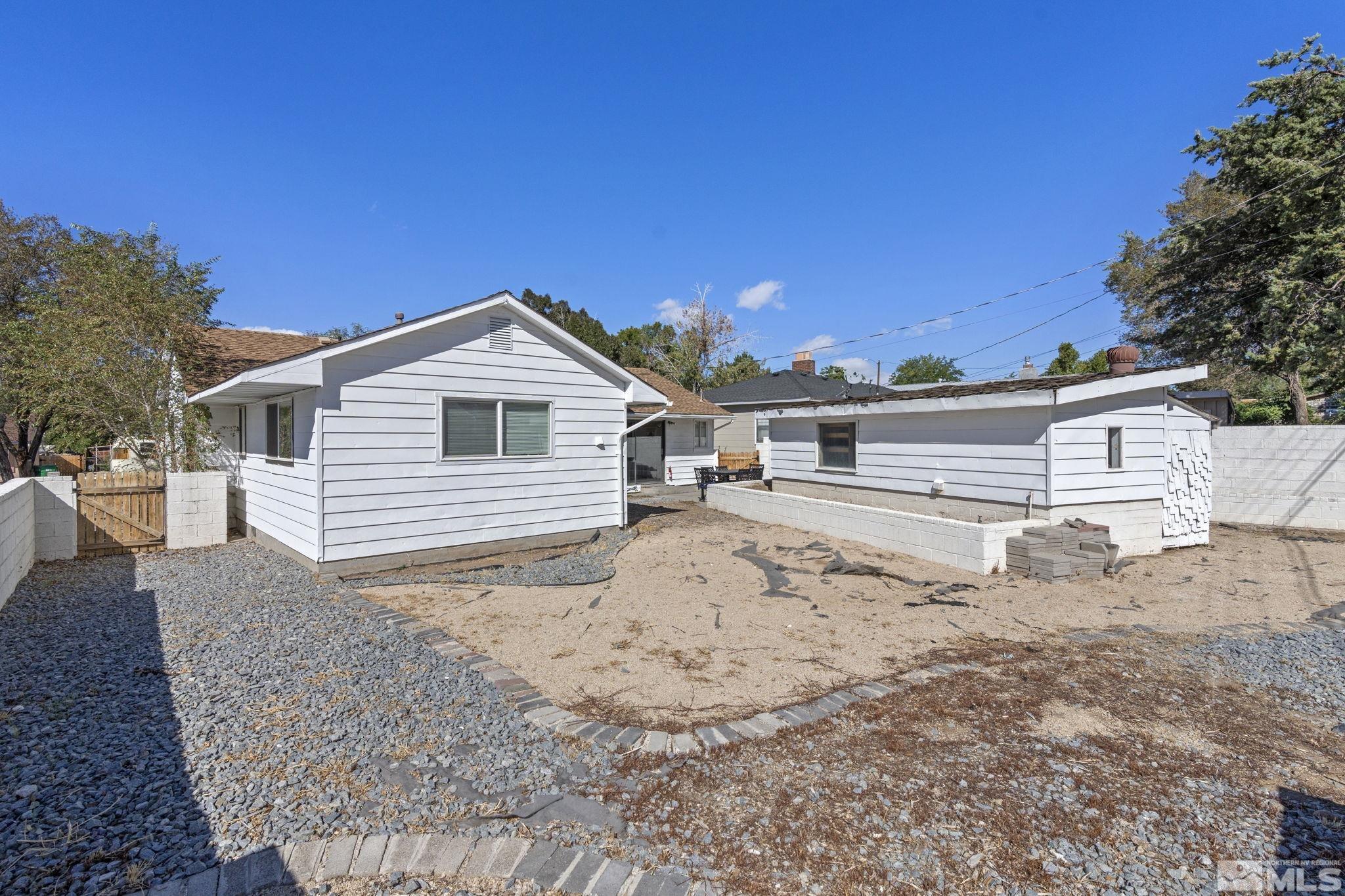 840 Bates Avenue Reno, NV 89502 - Photo 29 of 39 a front view of a house with a dirt yard and a large tree