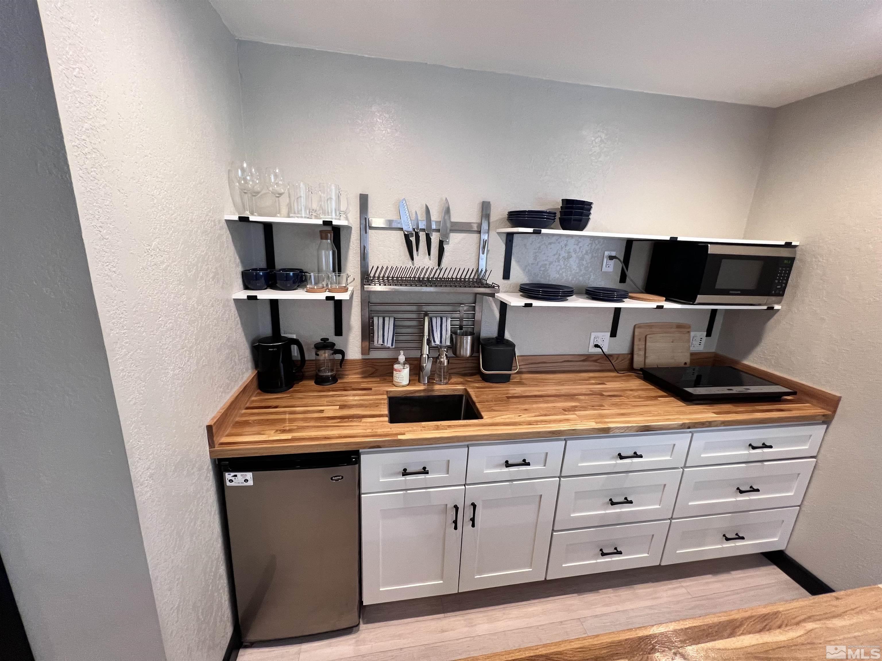 840 Bates Avenue Reno, NV 89502 - Photo 35 of 39 a kitchen with white cabinets and sink