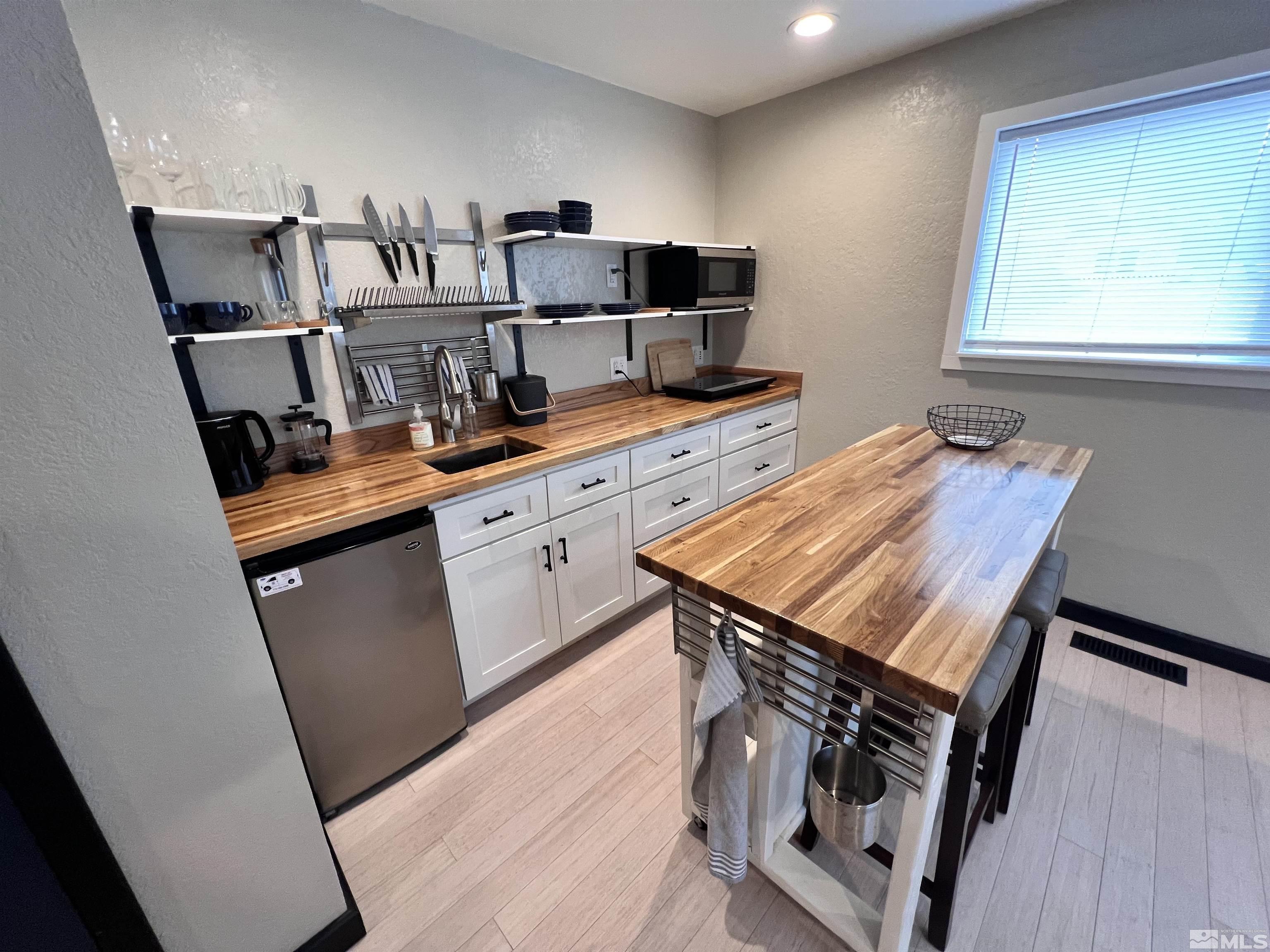 840 Bates Avenue Reno, NV 89502 - Photo 36 of 39 a view of kitchen with sink refrigerator stove and wooden floor