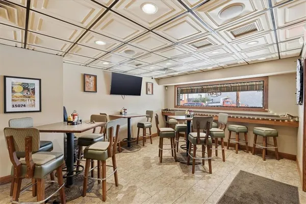a living room with stainless steel appliances granite countertop furniture and a table