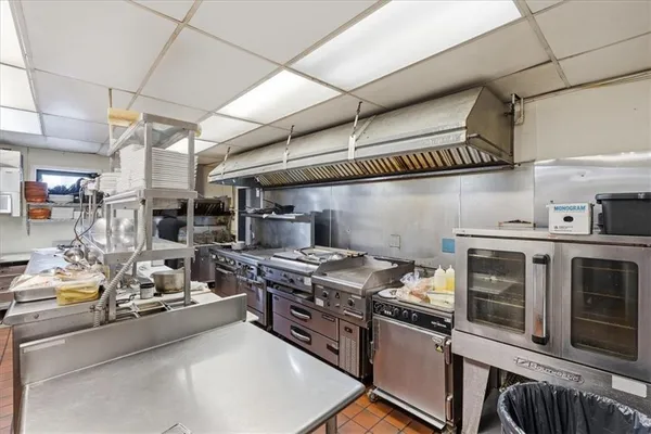 a kitchen with stainless steel appliances lots of counter space and wooden floor