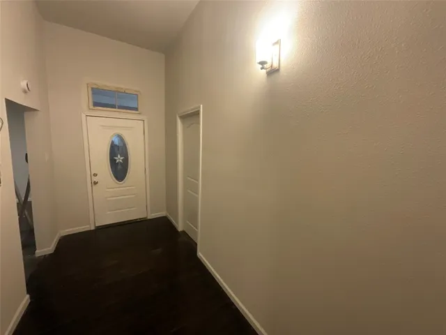 a view of hallway with wooden floor