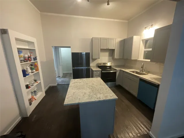 a kitchen with stainless steel appliances granite countertop a sink stove and refrigerator