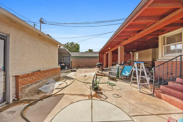 a view of a patio with table and chairs with wooden floor and plants