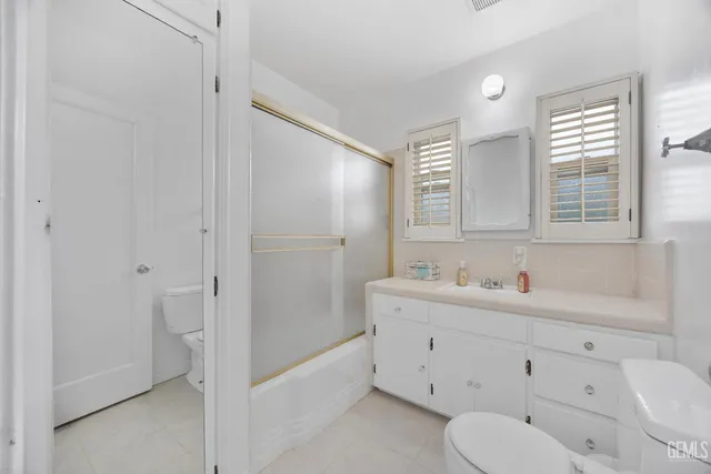 a spacious bathroom with a toilet sink and shower