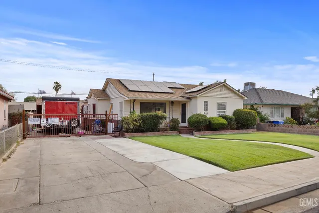 a view of a house with a yard and sitting area