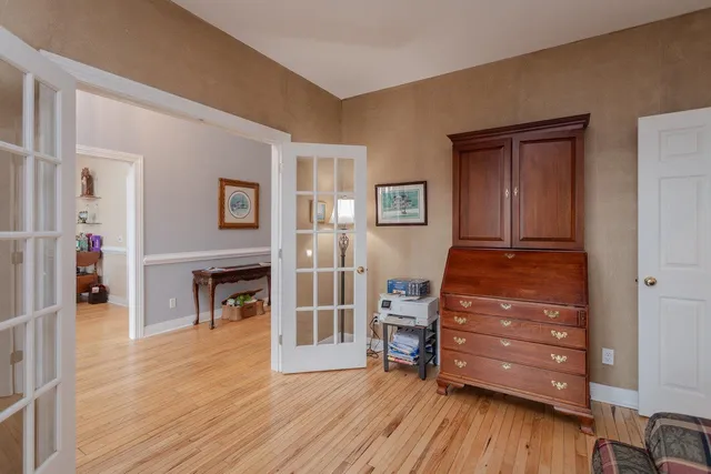 a kitchen with stainless steel appliances granite countertop a lot of counter space and wooden floors