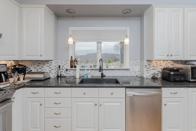 a kitchen with a sink dining table and chairs