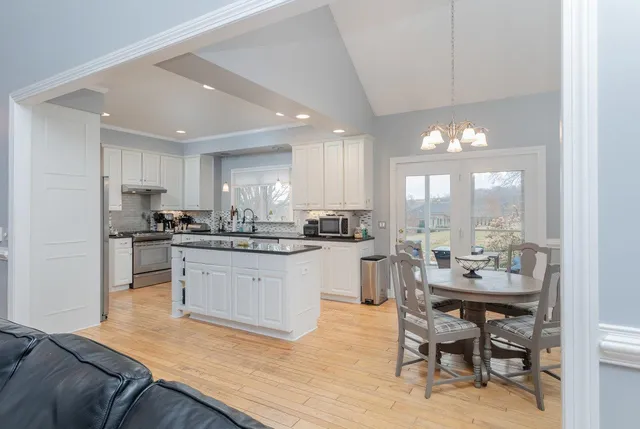 a bathroom with a granite countertop sink a mirror and shower