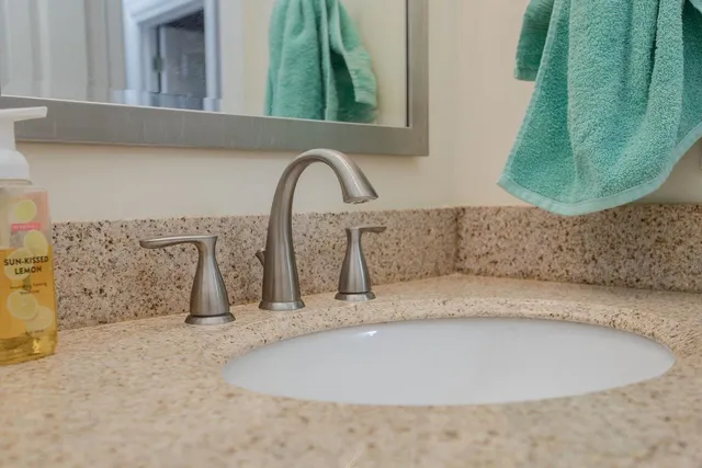 a bathroom with a sink vanity and mirror