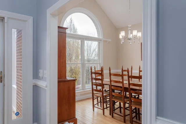 a view of a dining room with furniture and a large window