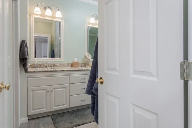a view of a hallway with wooden floor and furniture