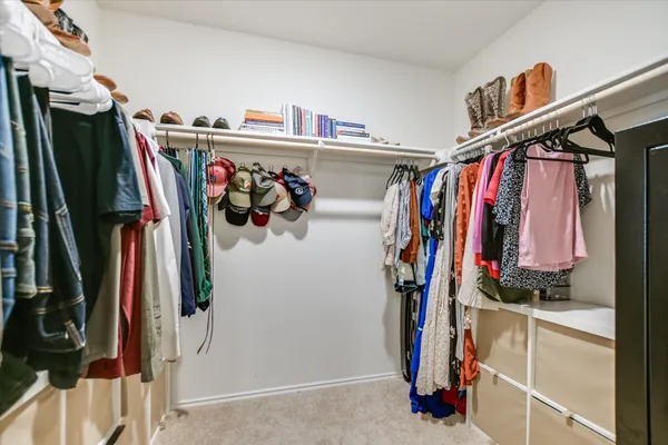 a kitchen with stainless steel appliances a stove a microwave a sink and white cabinets
