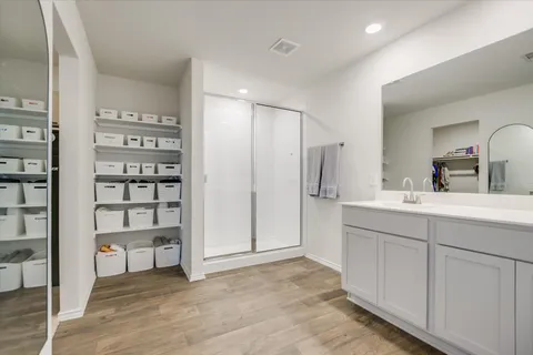a spacious bedroom with a bed and a chandelier