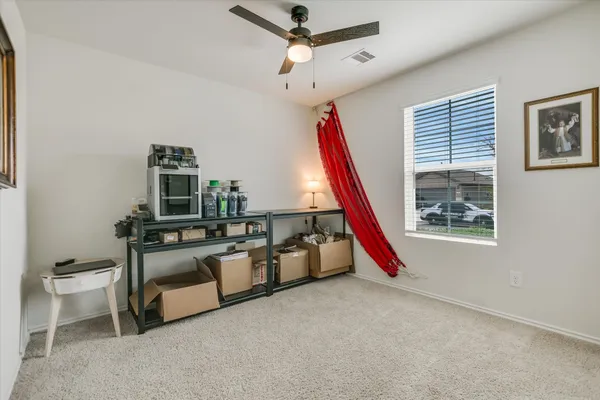 a view of a room with furniture and a window
