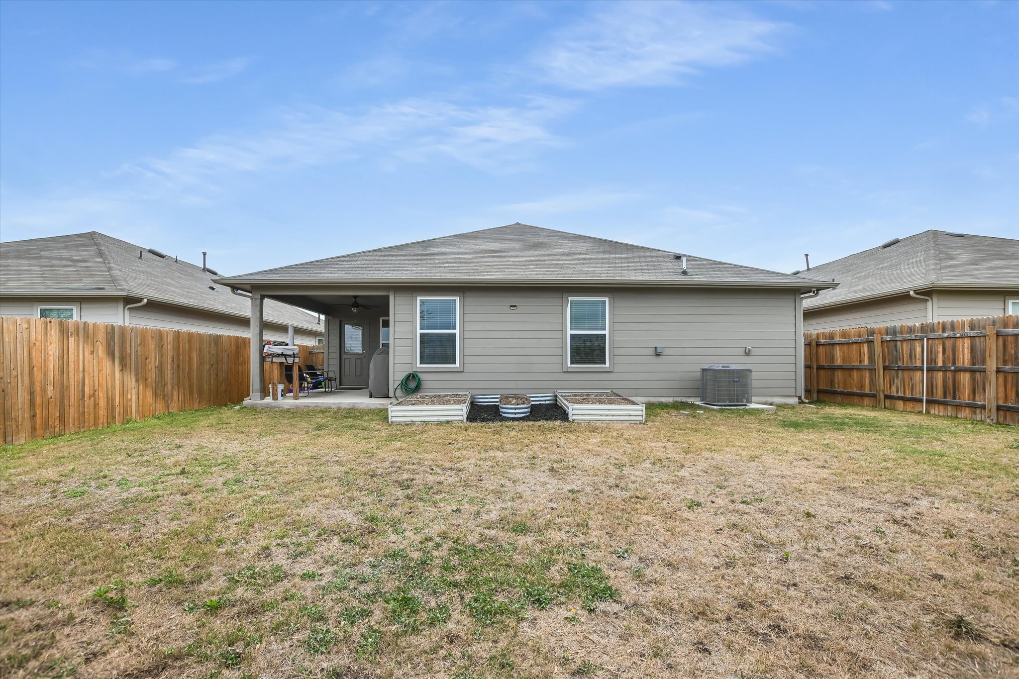 262 Sickle Loop Kyle, TX 78640 - Photo 16 of 20 Rear view of house with a patio area and a fenced backyard