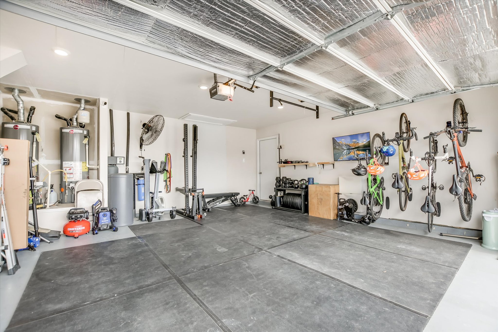262 Sickle Loop Kyle, TX 78640 - Photo 18 of 20 Garage with water heater and a garage door opener