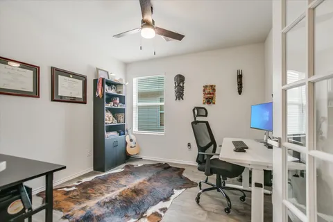 a view of a workspace with furniture and a window