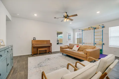 a living room with furniture and kitchen view