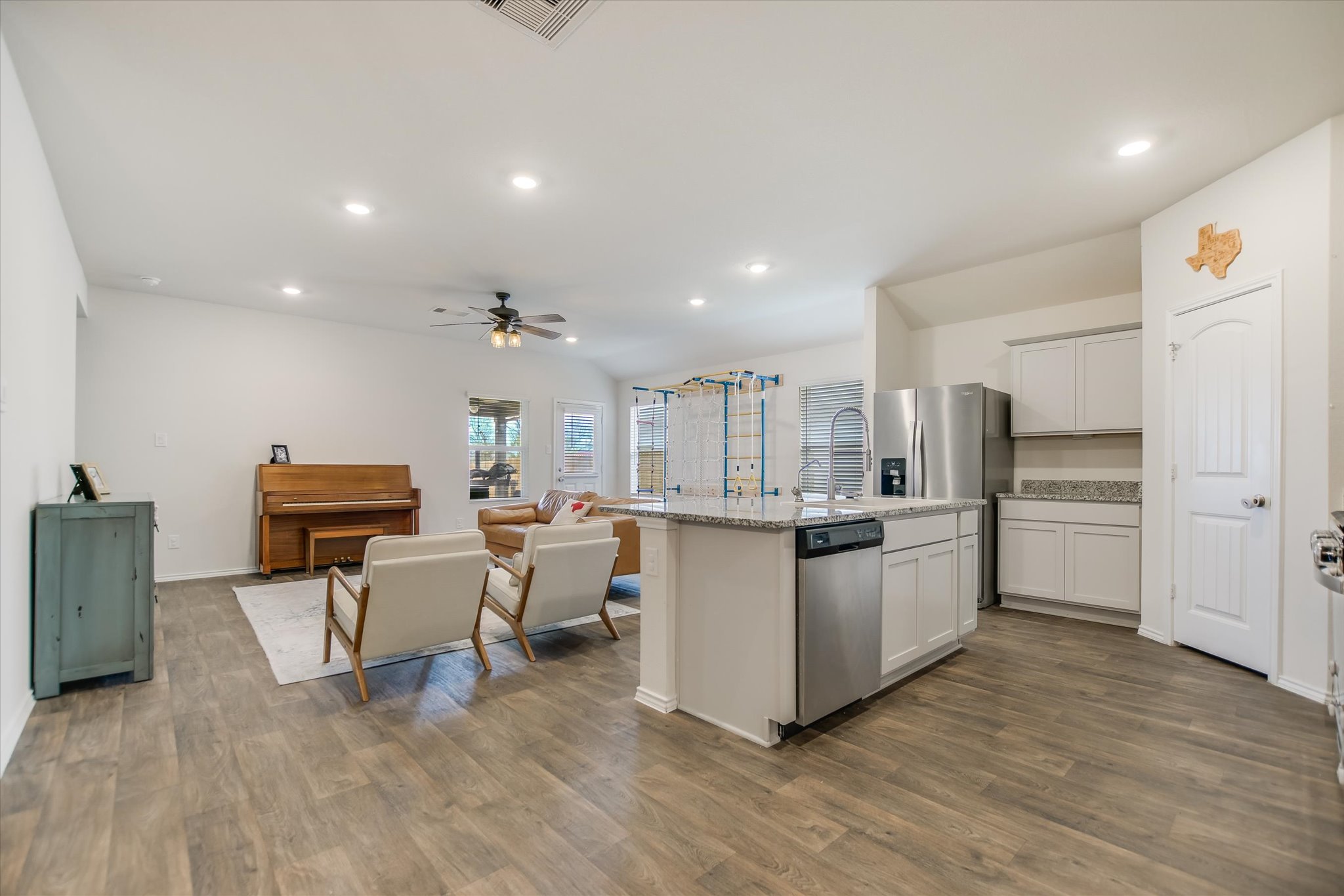 262 Sickle Loop Kyle, TX 78640 - Photo 20 of 20 Kitchen featuring open floor plan, an island with sink, stainless steel appliances, recessed lighting, and white cabinets