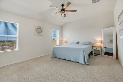 a large kitchen with kitchen island a stove a refrigerator a sink and a dining table with wooden floor