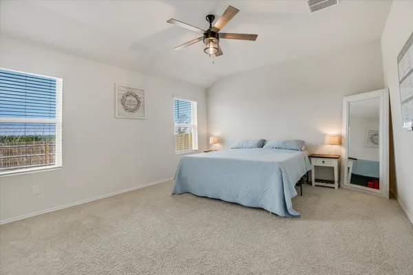 a large kitchen with kitchen island a stove a refrigerator a sink and a dining table with wooden floor