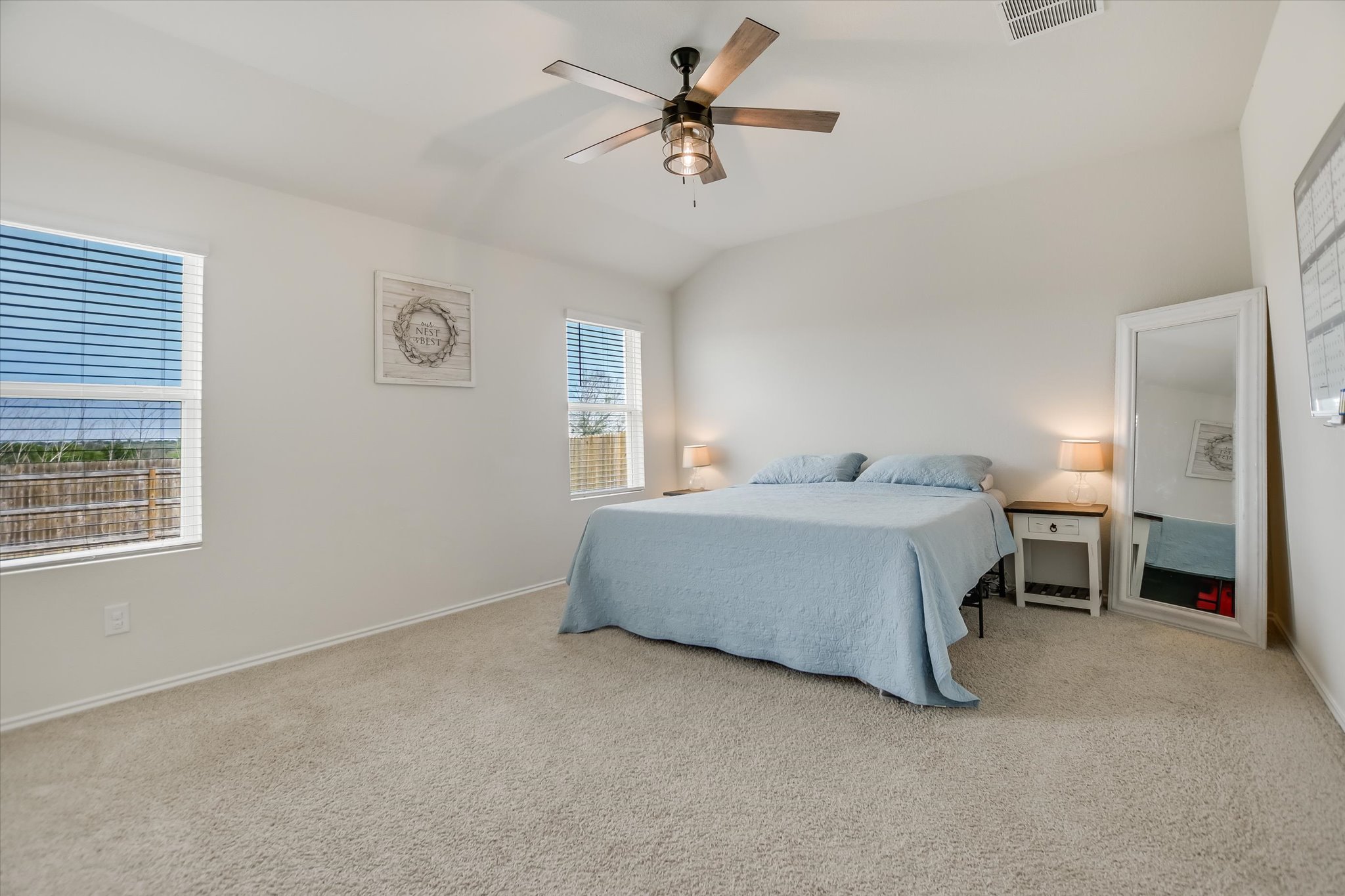 262 Sickle Loop Kyle, TX 78640 - Photo 8 of 20 Bedroom with light colored carpet, lofted ceiling, and a ceiling fan