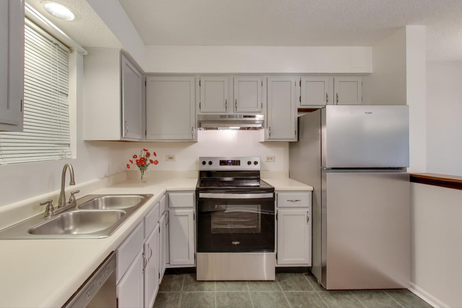 800 Ridge Road, Unit 114 Wilmette, IL 60091 - Photo 13 of 23 a kitchen with a stove sink and refrigerator
