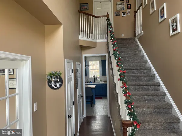 a view of a hallway to a house and wooden floor