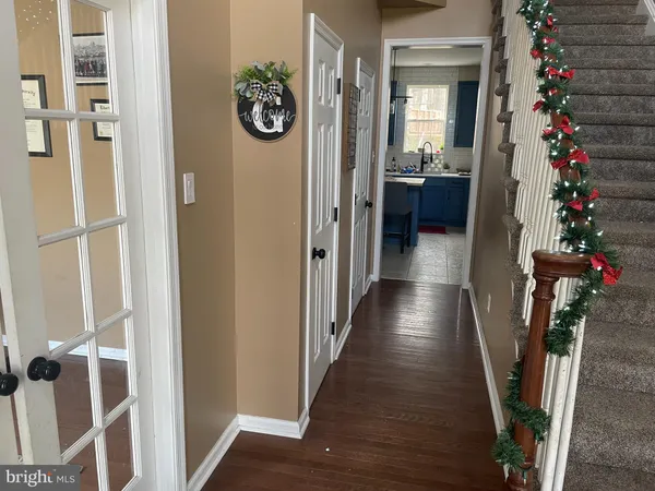 a view of a hallway with wooden floor and stairs