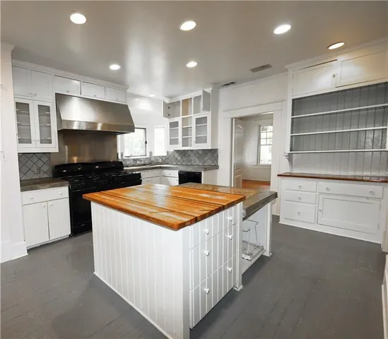 a kitchen with stainless steel appliances granite countertop a stove and a sink