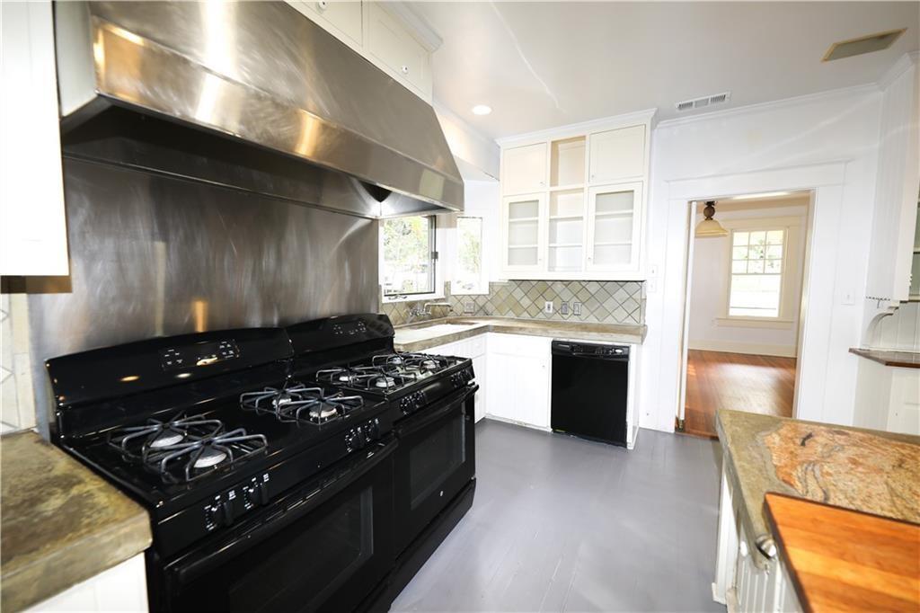 1305 Lorrain Street Austin, TX 78703 - Photo 8 of 36 a kitchen with a stove a sink and a microwave