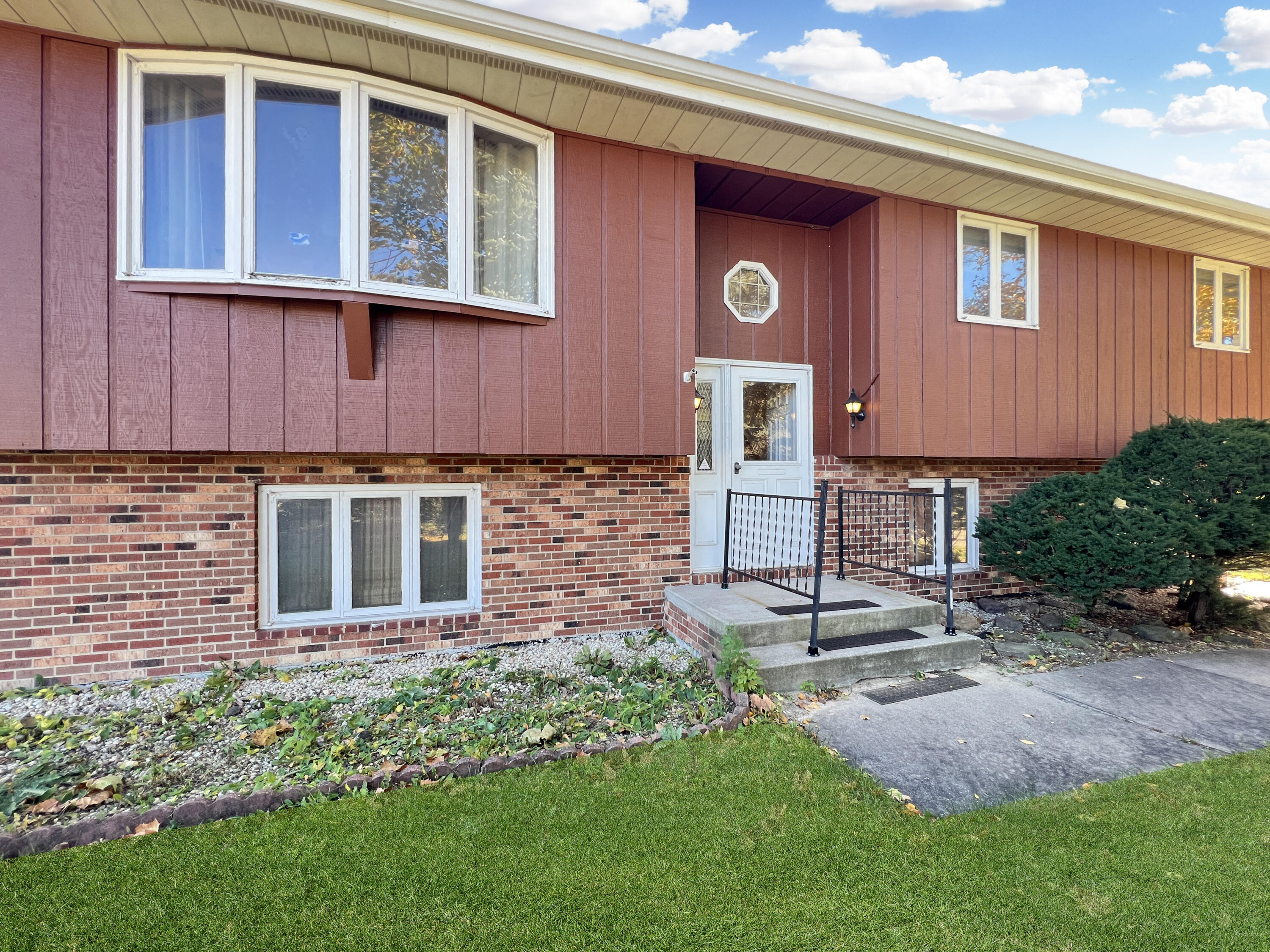 7431 West 83rd Lane Crown Point, IN 46307 - Photo 1 of 13 a front view of a house with garden
