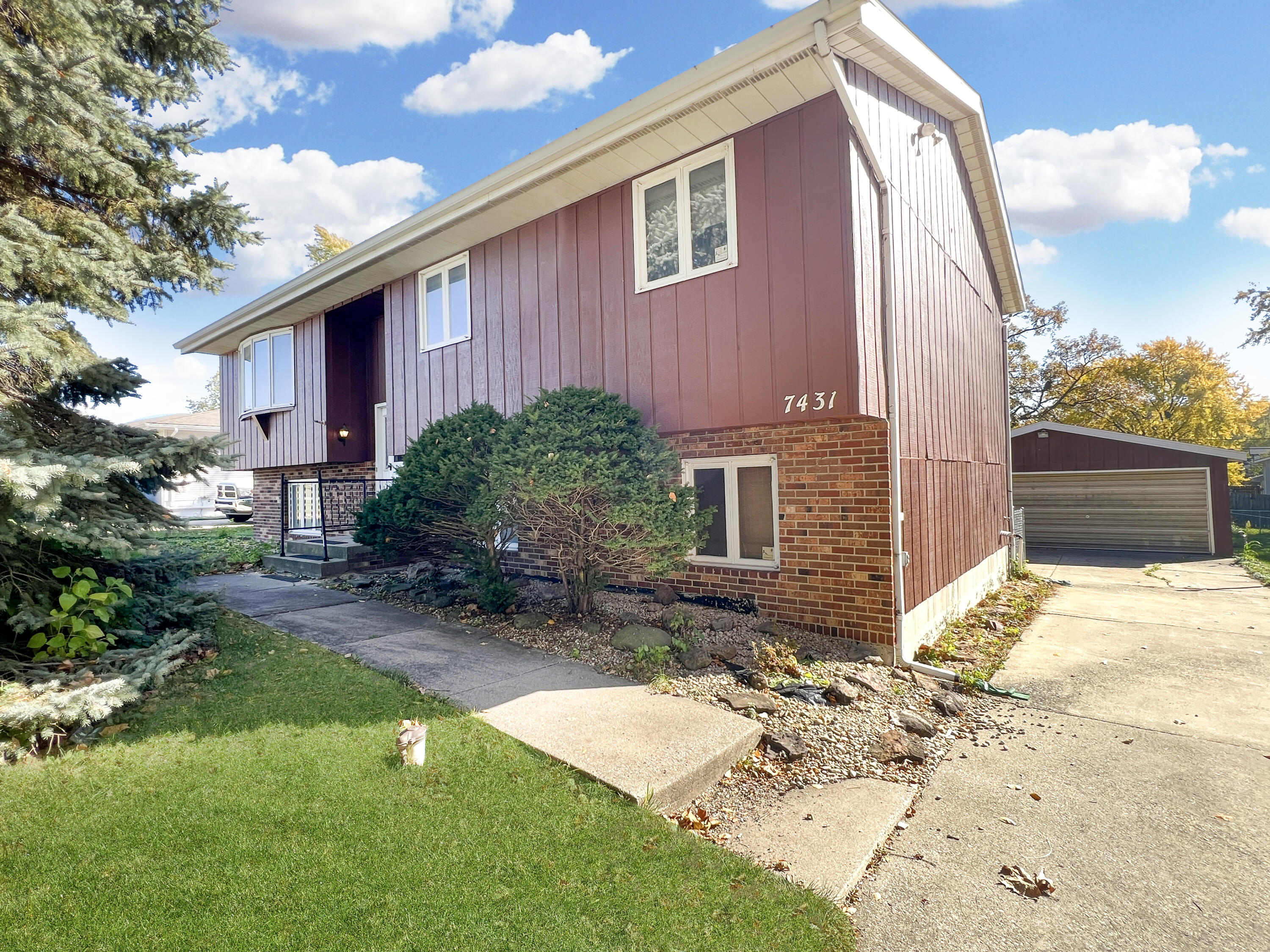 7431 West 83rd Lane Crown Point, IN 46307 - Photo 2 of 13 a backyard of a house with yard and outdoor seating