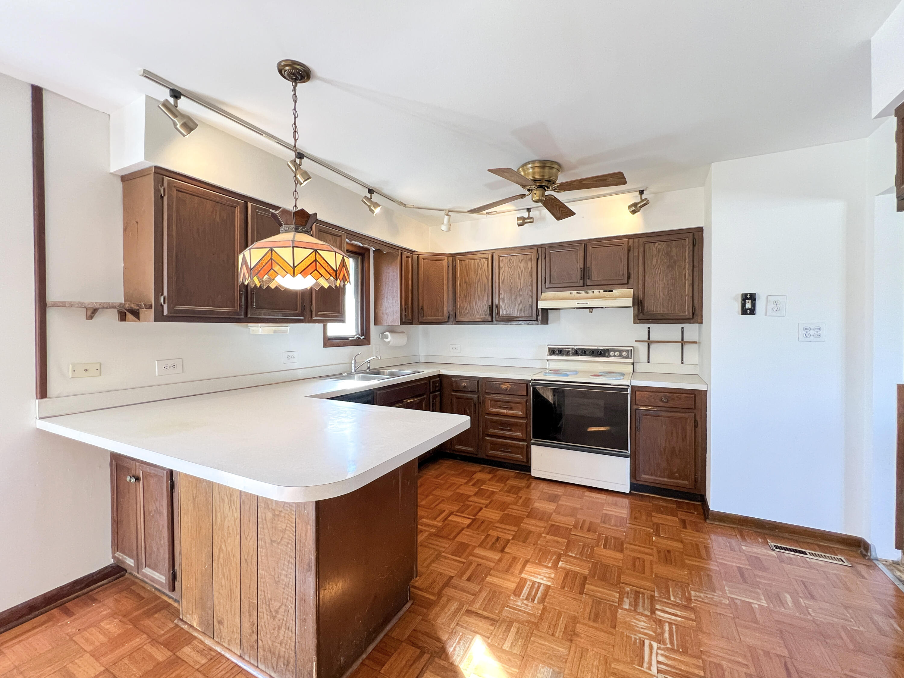 7431 West 83rd Lane Crown Point, IN 46307 - Photo 5 of 13 a kitchen with stainless steel appliances granite countertop a sink a stove and a refrigerator