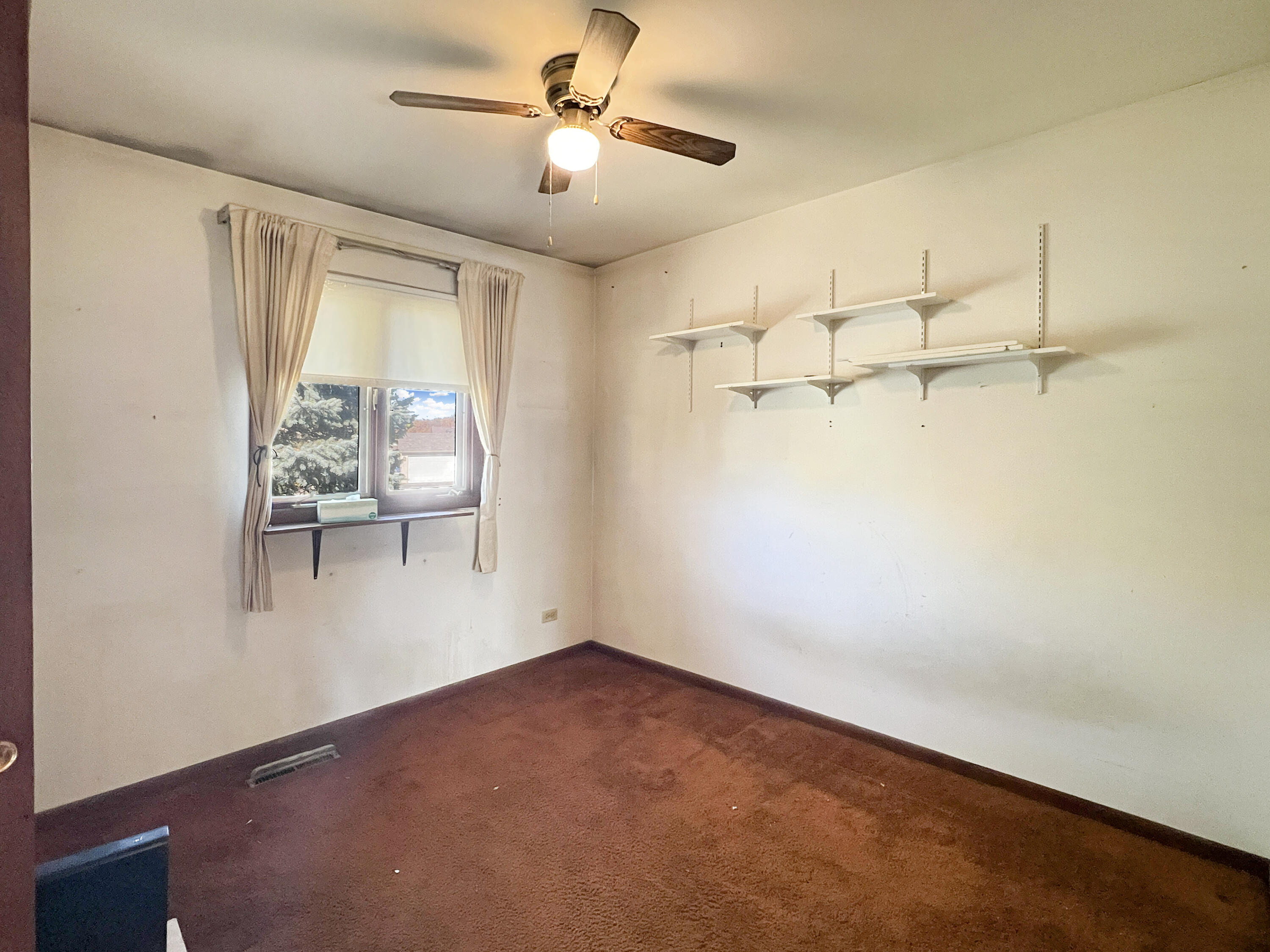 7431 West 83rd Lane Crown Point, IN 46307 - Photo 9 of 13 an empty room with windows and fan