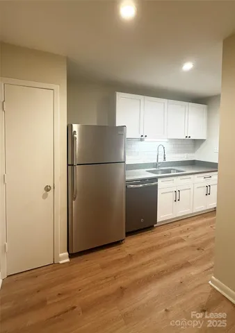 a view of empty room with wooden cabinet