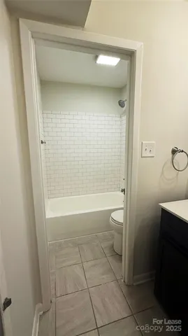 a view of a house with a yard and potted plants