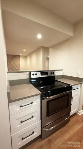 a kitchen with a refrigerator and a stove