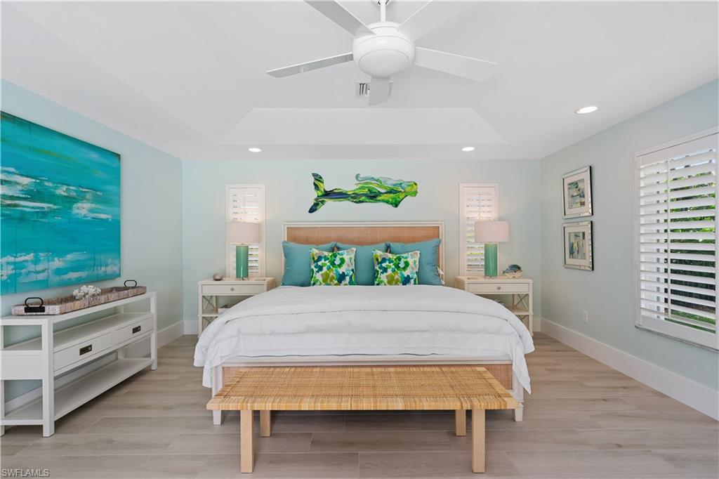 521 Turtle Hatch Road Naples, FL 34103 - Photo 13 of 34 a bedroom with a bed and a flat screen tv