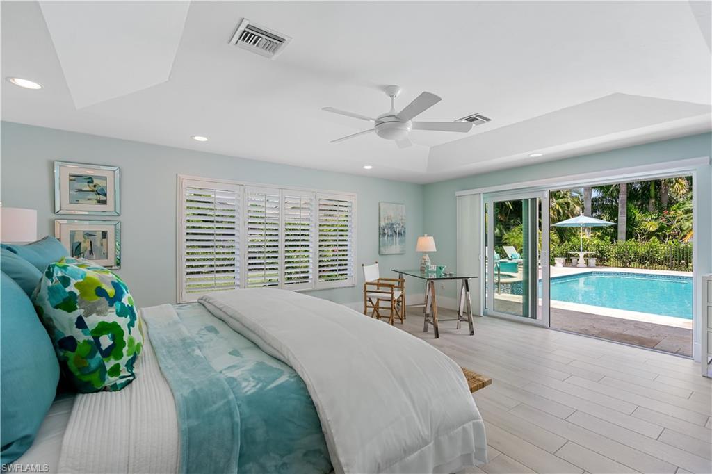 521 Turtle Hatch Road Naples, FL 34103 - Photo 14 of 34 a spacious bedroom with a large bed and a large window