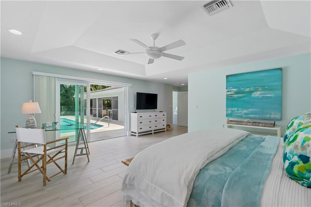 521 Turtle Hatch Road Naples, FL 34103 - Photo 15 of 34 a bedroom with a bed window and table