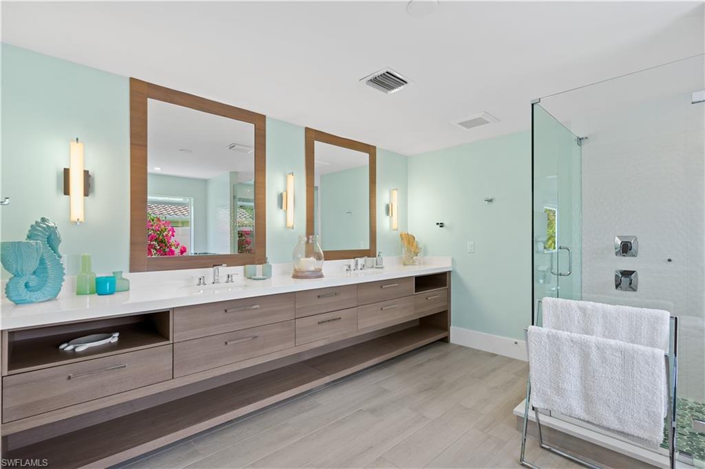 521 Turtle Hatch Road Naples, FL 34103 - Photo 17 of 34 a room with two sink and a mirror