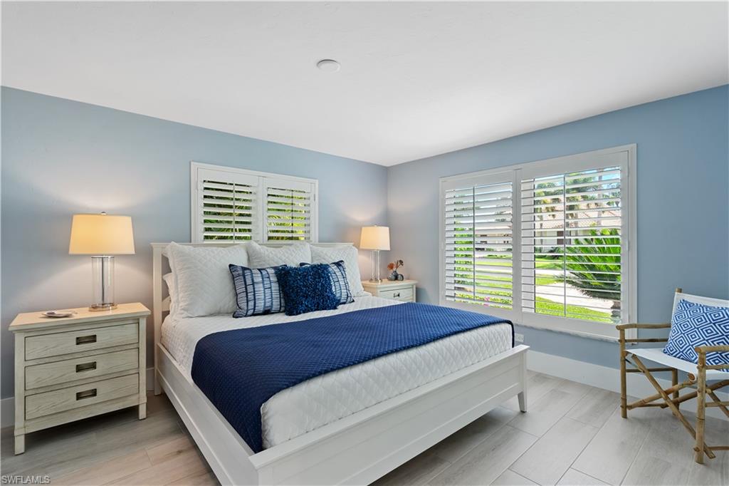 521 Turtle Hatch Road Naples, FL 34103 - Photo 18 of 34 a bedroom with a bed and a window