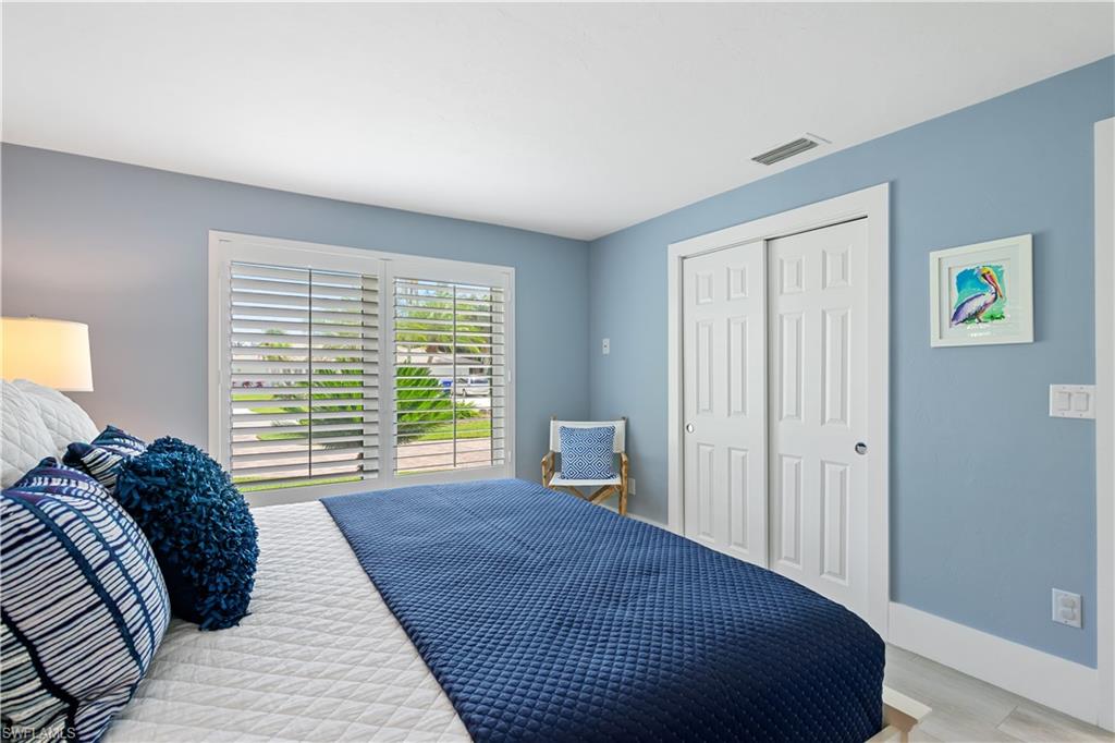 521 Turtle Hatch Road Naples, FL 34103 - Photo 19 of 34 a bed sitting in a bedroom next to a window