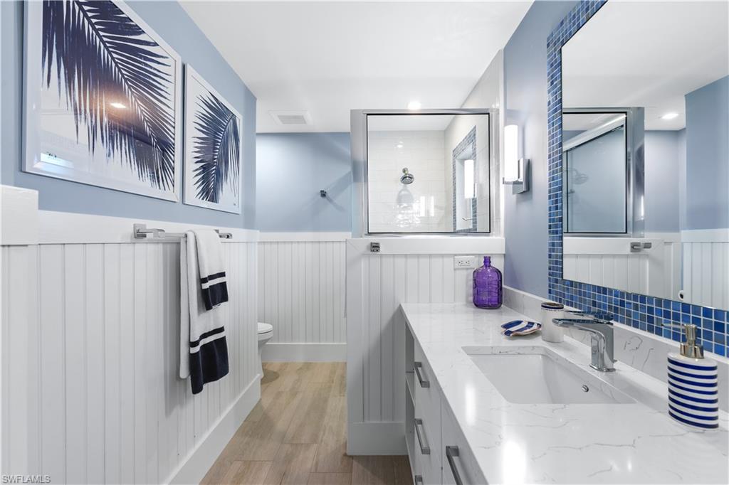 521 Turtle Hatch Road Naples, FL 34103 - Photo 20 of 34 a bathroom with a sink a toilet and a mirror