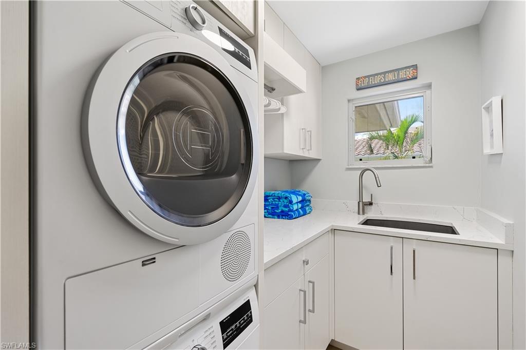 521 Turtle Hatch Road Naples, FL 34103 - Photo 24 of 34 a kitchen with a sink and a washer dryer
